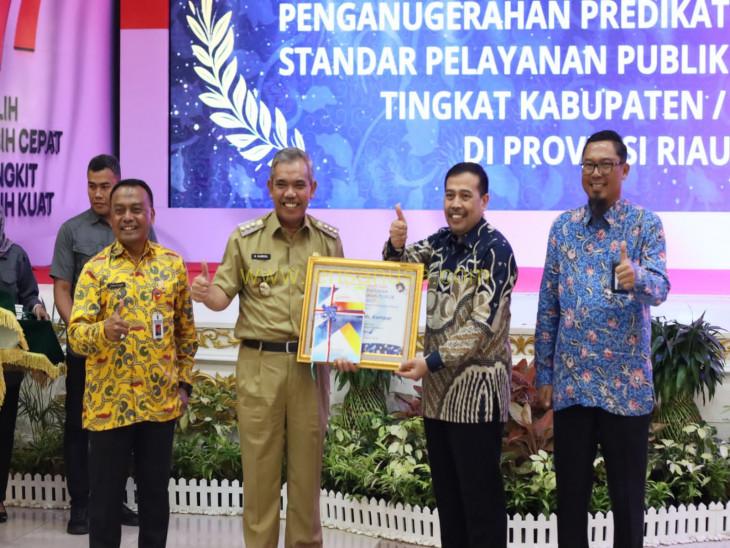 Pj Bupati Kampar Dr. H. Kamsol, MM Menerima Piagam penghargaan predikat Kepatuhan Standar Pelayanan Publik Tahun 2022